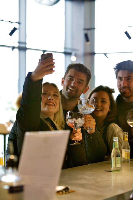 group of people at a bar enjoying Orkney Gin